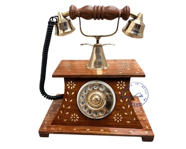 Vintage-style wooden rotary dial telephone with brass accents and floral inlay.